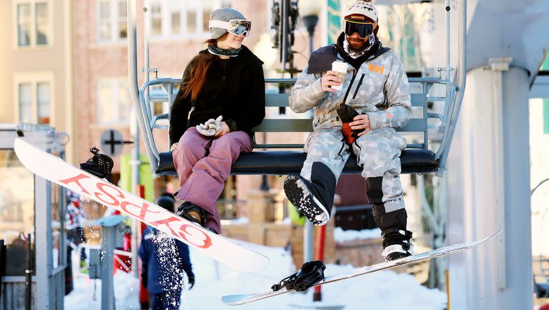 Snowboarders ride a lift in Park City on Tuesday, Jan. 11, 2022. What are the best ski towns in the nation to live in?