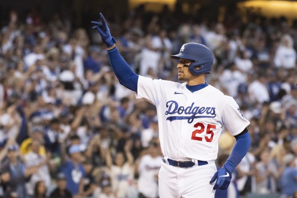 The Dodgers' Trayce Thompson gestures toward the stands after hitting a three-run home run.