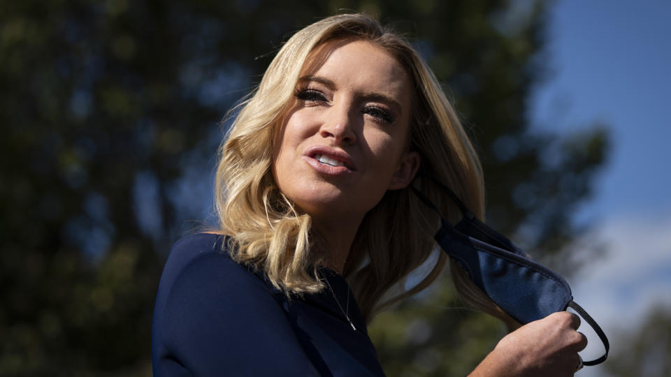 White House Press Secretary Kayleigh McEnany takes off her face covering before speaking with reporters outside the West Wing of the White House on October 2, 2020 in Washington, DC. (Drew Angerer/Getty Images)