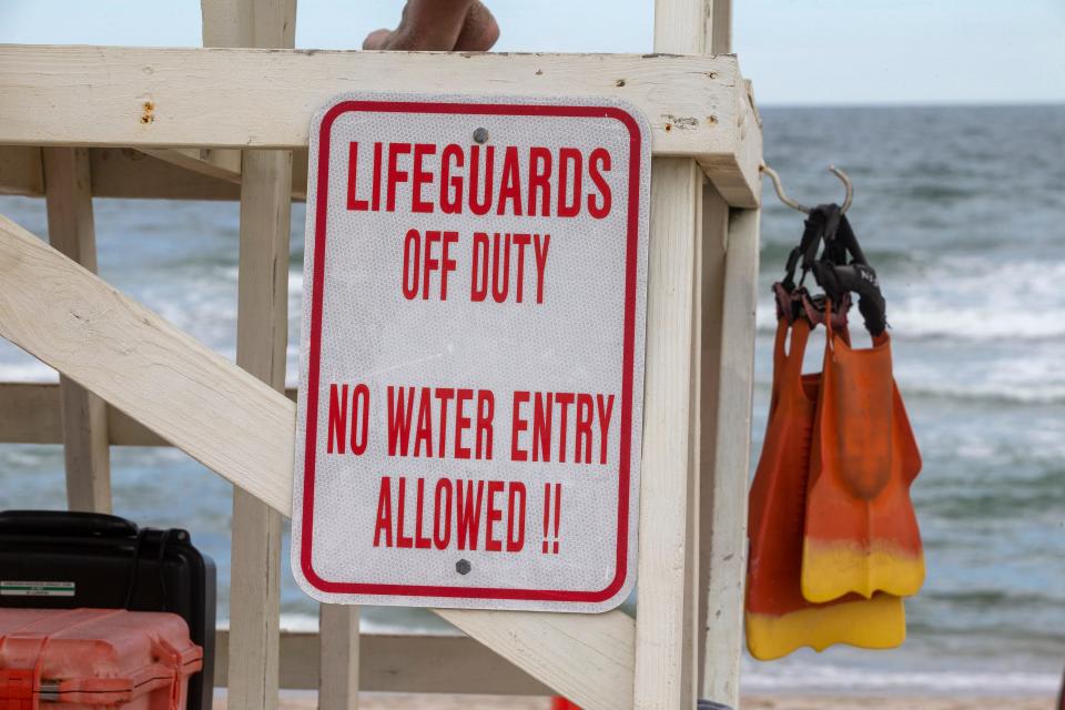 A sign at Brick Beach III warns against swimming when lifeguards are off duty, on June 23, 2022.