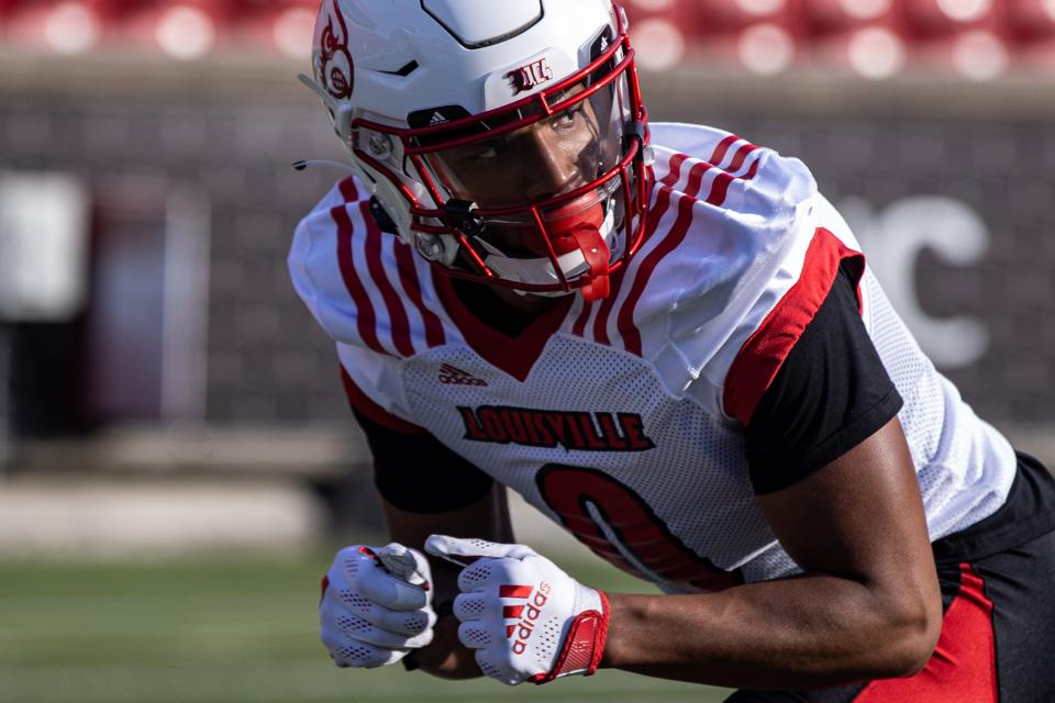 Wide receiver Tyler Hudson, right, prepares to run a route during U of L's first spring football practice of 2022 on Monday afternoon. Feb. 28, 2022