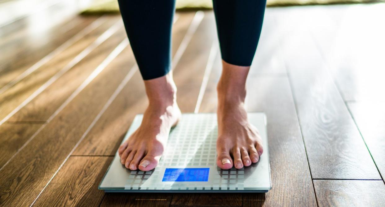 BMI weight - woman's feet standing on scales. (Getty Images)