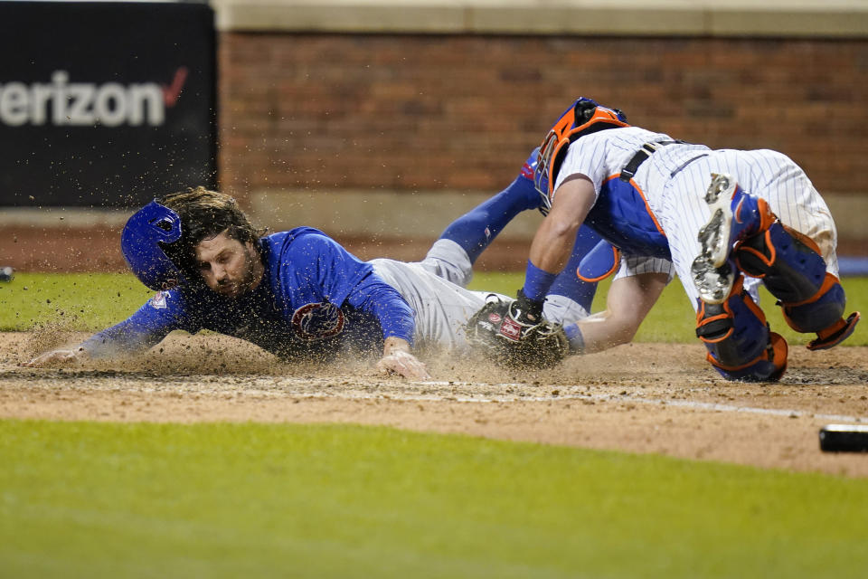 New York Mets catcher James McCann, right, tags out Chicago Cubs' Jake Marisnick (6) at home plate during the ninth inning of a baseball game Tuesday, June 15, 2021, in New York. (AP Photo/Frank Franklin II)