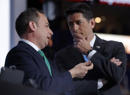 Republican National Committee Chairman Reince Priebus (L) and Speaker of the House and Chairman of the convention Paul Ryan confer on what to do after the Alaska delegation demanded that their votes for candidates other than Donald Trump be counted and recorded at the Republican National Convention in Cleveland, Ohio, U.S. July 19, 2016. REUTERS/Brian Snyder