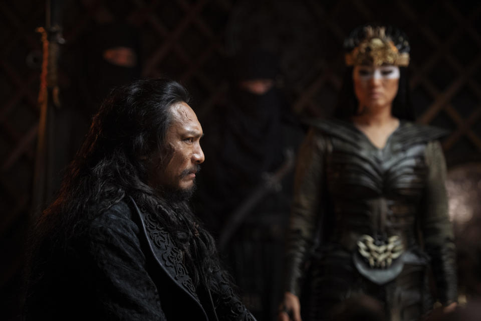 This image released by Disney shows Jason Scott Lee, left, and Gong Li in a scene from "Mulan." (Jasin Boland/Disney via AP)