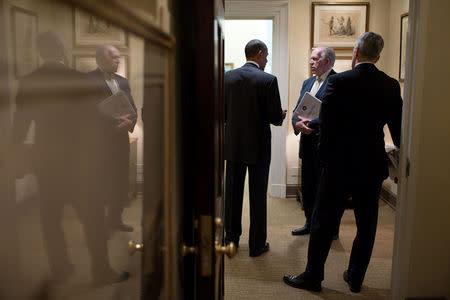 U.S. President Barack Obama talks with CIA Director John Brennan (C), and Chief of Staff Denis McDonough in a West Wing hallway at the White House in Washington, DC, U.S. on May 10, 2013. Courtesy Pete Souza/The White House/Handout via REUTERS