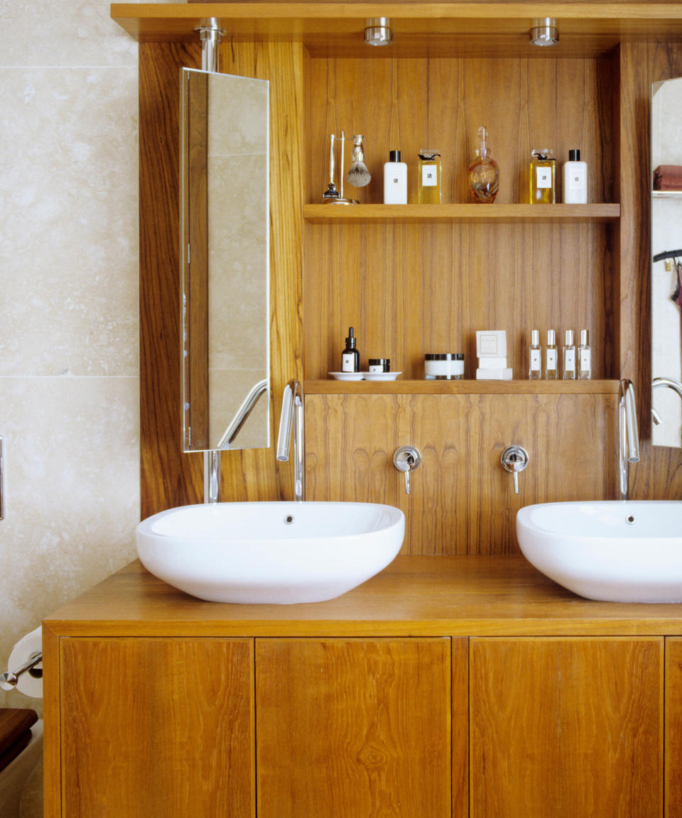 wooden vanity with two sinks and shelving