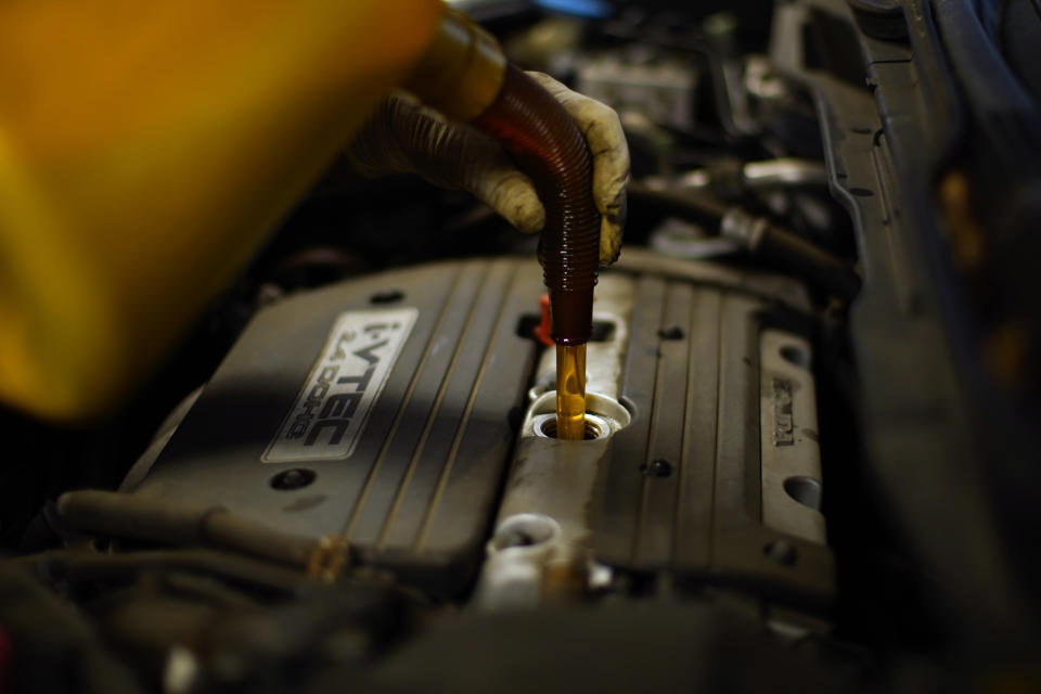 A mechanic fills a car with oil at an auto repair shop, Wednesday, July 13, 2022, in Collingdale, Pa. Surging prices for gas, food and rent catapulted U.S. inflation to a new four-decade peak in June, further pressuring households and likely sealing the case for another large interest rate hike by the Federal Reserve, with higher borrowing costs to follow. Consumer prices soared 9.1% compared with a year earlier, the government said Wednesday, July 13, 2022, the biggest 12-month increase since 1981, and up from an 8.6% jump in May. (AP Photo/Matt Slocum)