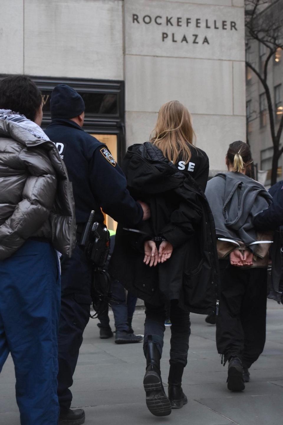 Hunter Schafer and at least 30 individuals were taken into custody following protests at NBC's 30 Rockefeller Center headquarters.