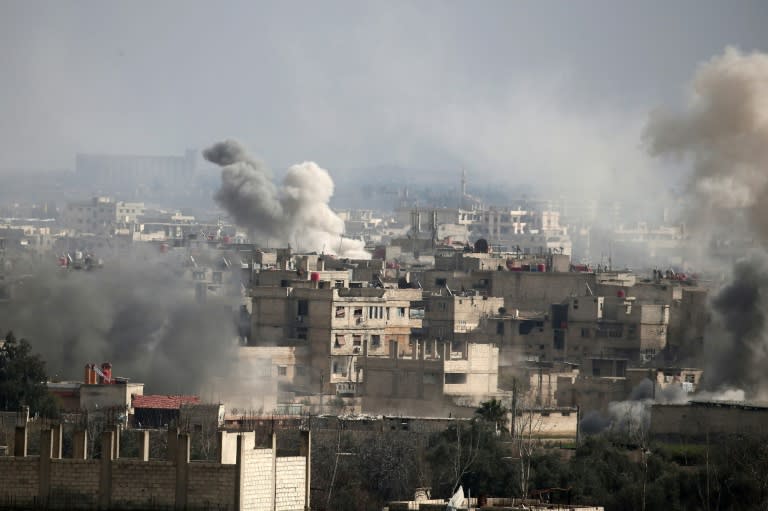 Smoke plumes rise following a reported regime air strike in the rebel-held town of Hammuriyeh, in the besieged Eastern Ghouta region outside Damascus on February 20, 2018