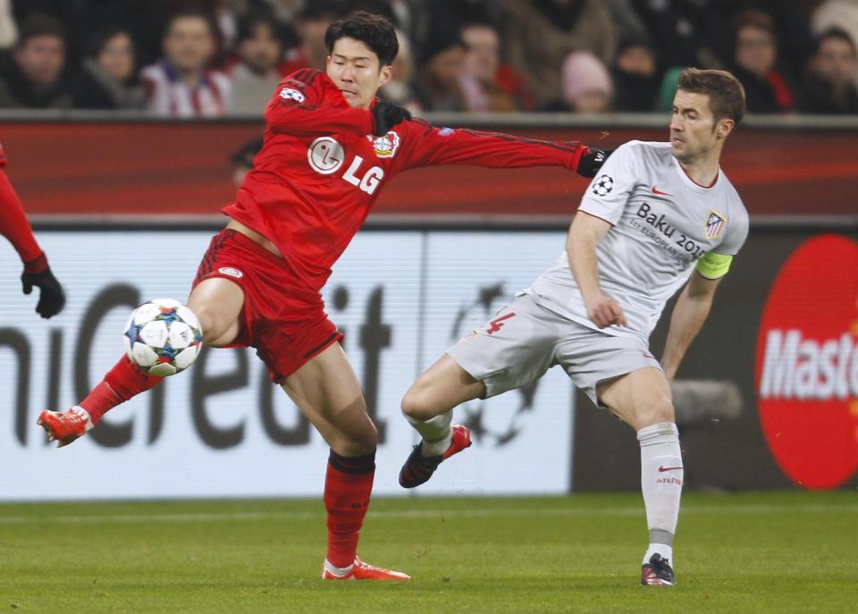 Bayer Leverkusen's Heung-Min Son challenges Atletico Madrid's Gabi during Champions League soccer match in Leverkusen