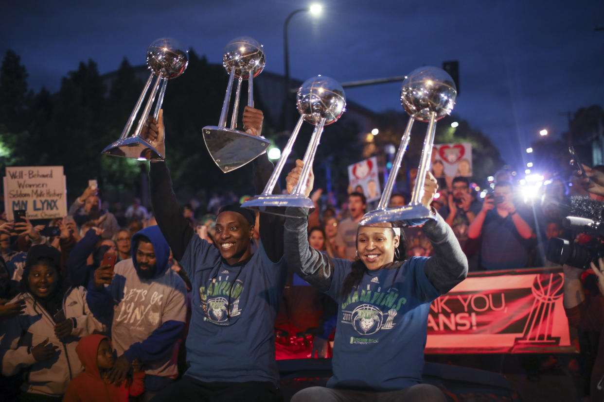 Minnesota Lynx players Sylvia Fowles, left and Maya Moore celebrate their four WNBA championships. (AP Photo)