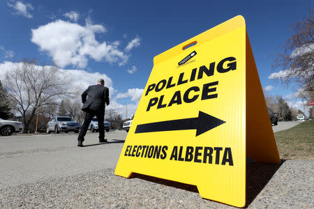 A man leaves a polling station as voters head to the polls in a provincial election in Calgary, Alberta, Canada, April 16, 2019. REUTERS/Chris Wattie