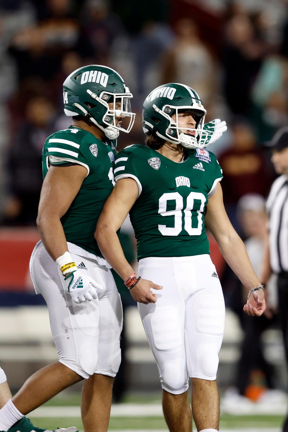 Tight end Bryce Butler reacts with place kicker Nathanial Vakos (90) of the Ohio Bobcats after Vakos kicked the game tying field goal during the second half of the Barstool Sports Arizona Bowl against the Wyoming Cowboys at Arizona Stadium on December 30, 2022 in Tucson, Arizona.