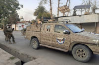 Afghan Special forces patrol a deserted street during fighting with the Taliban, in Lashkar Gah, Helmand province, southern Afghanistan, Tuesday, Aug. 3, 2021. The Taliban pressed ahead with their advances in southern Afghanistan on Tuesday, capturing nine out of 10 districts of the Helmand provincial capital, residents and officials said. The fall of Lashkar Gah would be a major turning point in the offensive the Taliban have waged over the past months as U.S. and NATO forces complete their pullout from the war-torn country. (AP Photo/Abdul Khaliq)