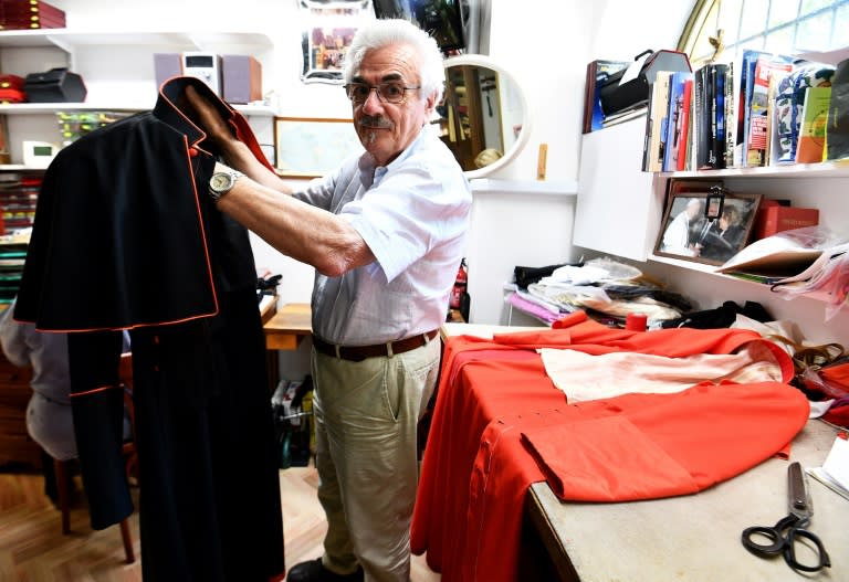 Italian tailor Raniero Mancinelli, 80, works on a cardinal robe at his workshop near the Vatican City