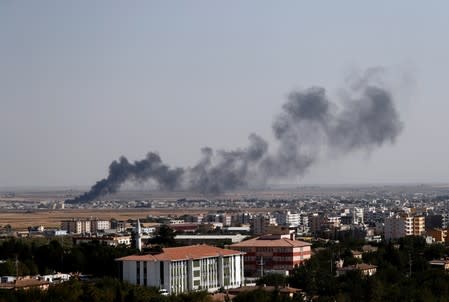 Smoke billows out after Turkish shelling on the Syrian town of Ras al Ain, as seen from the Turkish border town of Ceylanpinar