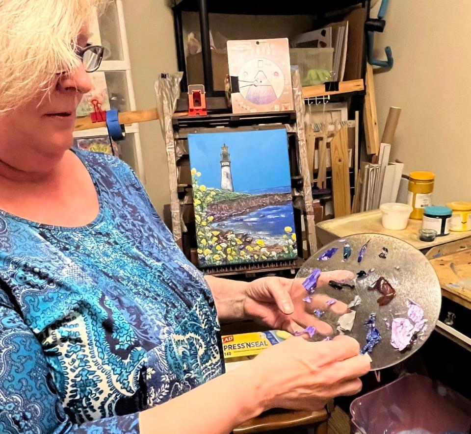 Artist Terrie Gordy demonstrates how she moves fragments of drying paint from a glass pallet to a canvas to create images.