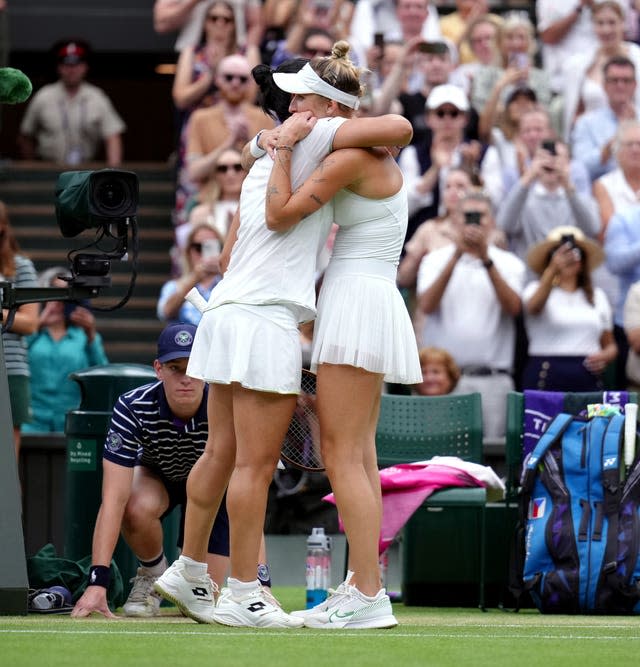 Vondrousova and Jabeur hugging on court