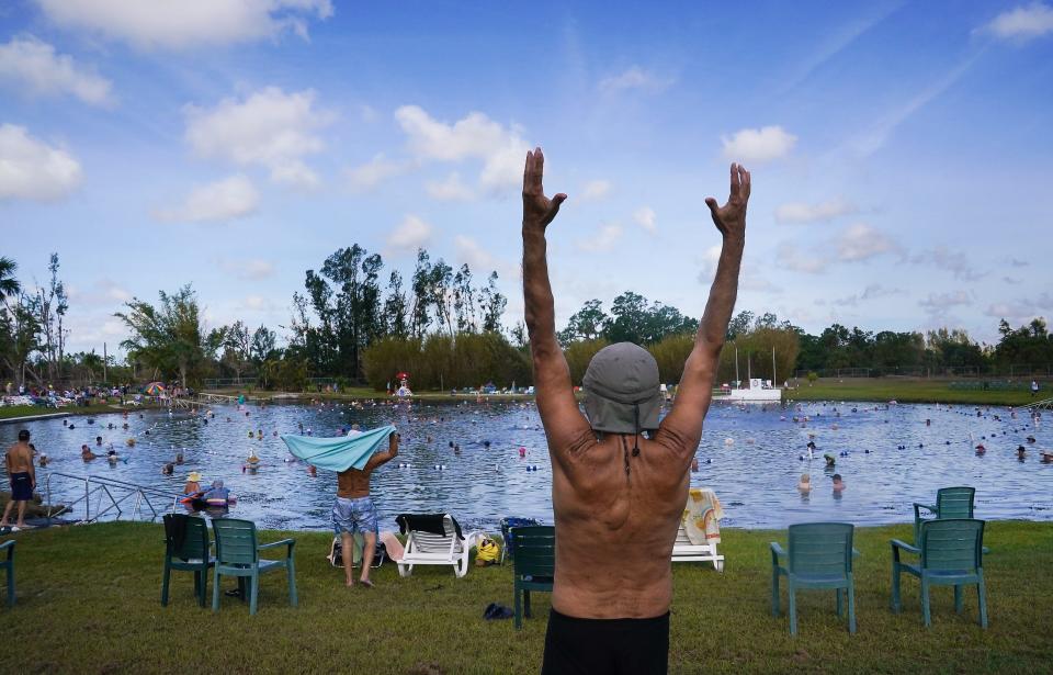 Christopher Wolski of Evans City, Penn., stretches before entering the water at Warm Mineral Springs Park on Friday.