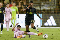 Inter Miami defender Tomas Aviles, bottom, attempts to slide-tackle Los Angeles FC forward Denis Bouanga (99) during the first half of an MLS soccer match, Sunday, Sept. 3, 2023, in Los Angeles. (AP Photo/Ryan Sun)