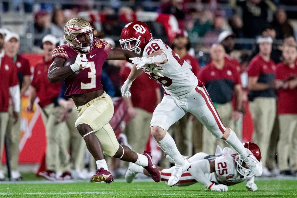 Florida State Seminoles running back Trey Benson (3) pushes off a defender as he sprints for the end zone The Florida State Seminoles defeated the Oklahoma Sooners 35-32 in the Cheez-It Bowl at Camping World Stadium on Thursday, Dec. 29, 2022.