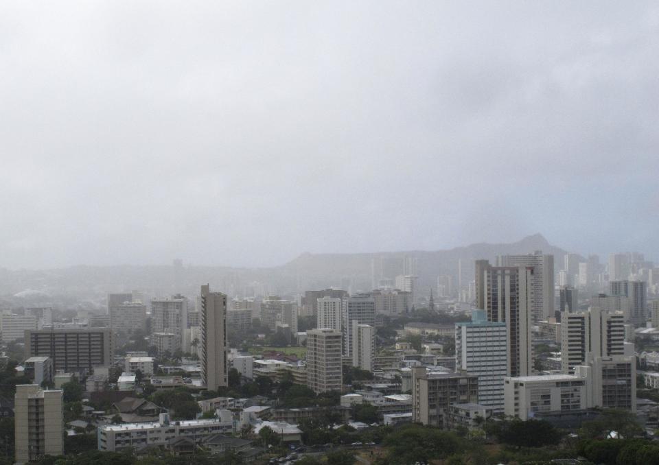 Diamond Head is shrouded in clouds in Honolulu as Tropical Storm Flossie approaches Hawaii on Monday, July 29, 2013. A tropical storm making its way toward Hawaii had residents of Maui and the Big Island on Monday bracing for possible flooding, 60 mph wind gusts and waves that could reach as high as 18 feet. Tropical Storm Flossie could also bring mudslides, tornadoes and waterspouts, forecasters said. (AP Photo/Audrey McAvoy)