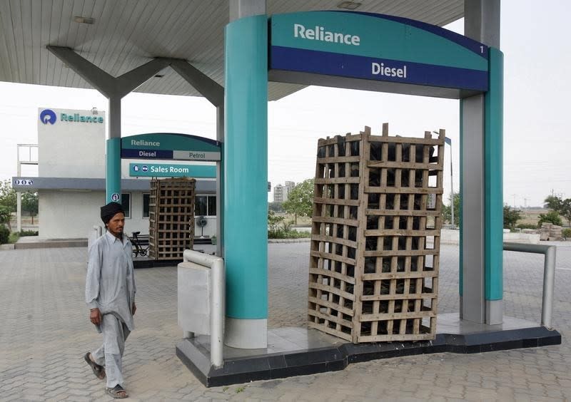 A watchman of Reliance's closed petrol station walks at Raipur Kalan village in Punjab May 7, 2010. REUTERS/Ajay Verma/Files