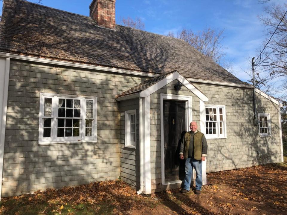 Robert McGregor stands by the ancient cottage. He plans to repair and restore the roof next.  (Jon Tattrie/CBC - image credit)