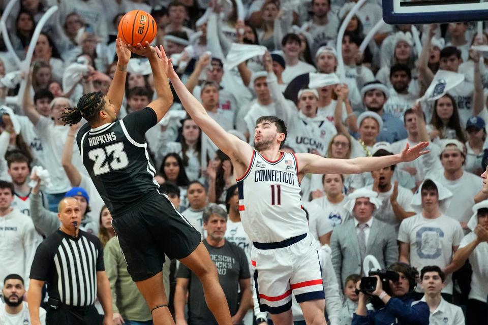 Providence forward Bryce Hopkins, who has averaged 17.7 points a game in his last 10 contest,  shoots over Connecticut's Alex Karaban  during their game last week. On Sunday, the Friars play at Georgetown.