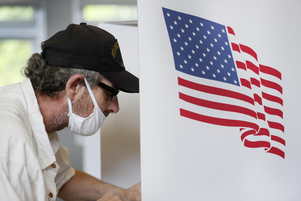 Louis Bender, of Des Moines, Iowa, fills out his ballot in Iowa's Primary Election at the Polk County Central Senior Center, Tuesday, June 2, 2020, in Des Moines, Iowa. (AP Photo/Charlie Neibergall)