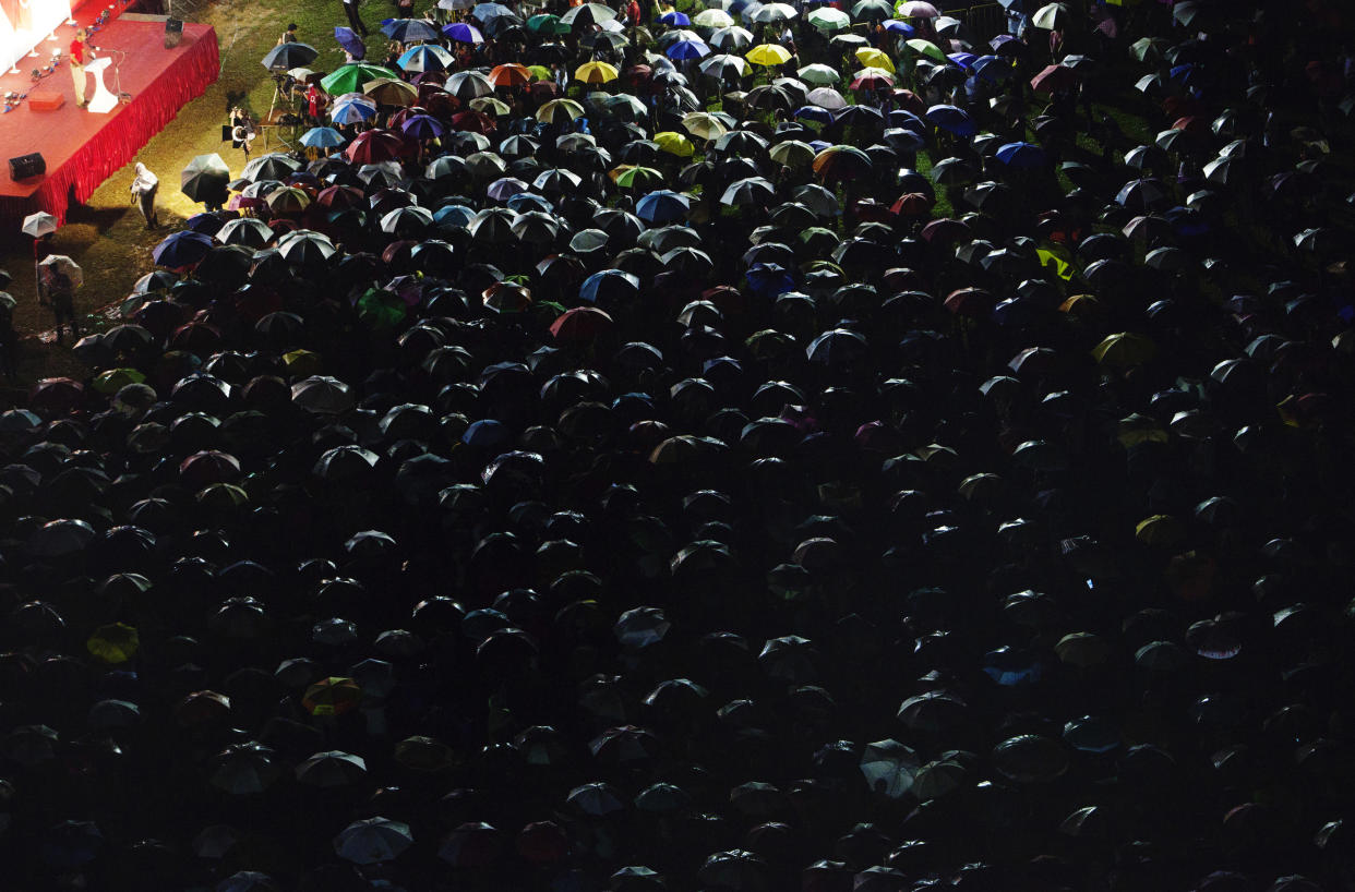 Supporters listen under their umbrellas during an opposition party's election rally in Singapore on 3 May, 2011. (Reuters file photo)