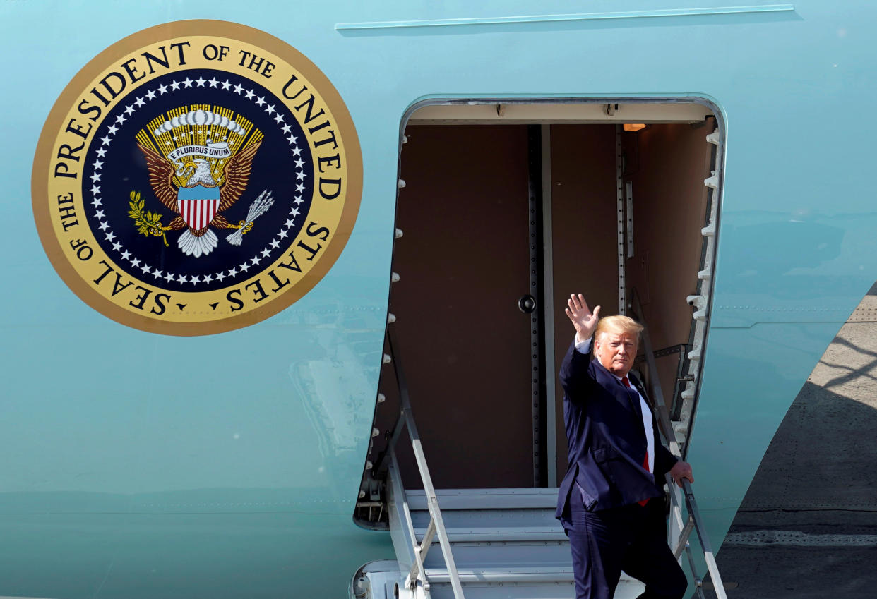 U.S. President Donald Trump waves as he disembarks Air Force One during a refueling stop at Joint Base Elmendorf, Alaska, U.S. on his way to the G-20 Summit in Osaka, Japan, June 26, 2019. REUTERS/Kevin Lamarque     TPX IMAGES OF THE DAY