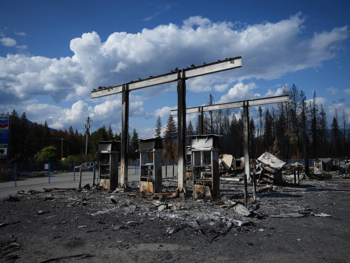 A gas station destroyed by a wildfire is seen in Squilax, B.C., last September. B.C., Alberta, Quebec and the Northwest Territories all had record wildfire seasons in 2023. (Darryl Dyck/The Canadian Press - image credit)