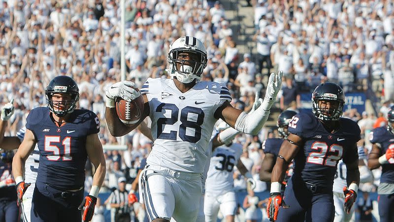 BYU’s Adam Hine begins to celebrate as he returns a kickoff, 99 yards for a touchdown as BYU and Virginia to play Saturday, Sept. 20, 2014, at LaVell Edwards Stadium in Provo. BYU won 41-33.