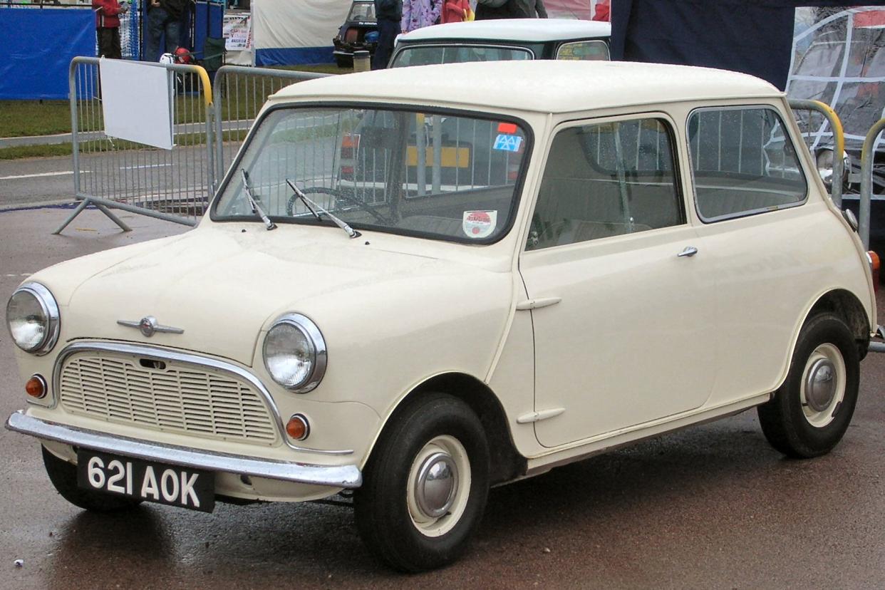 Beige Mini Cooper 1959 parked on rainy street
