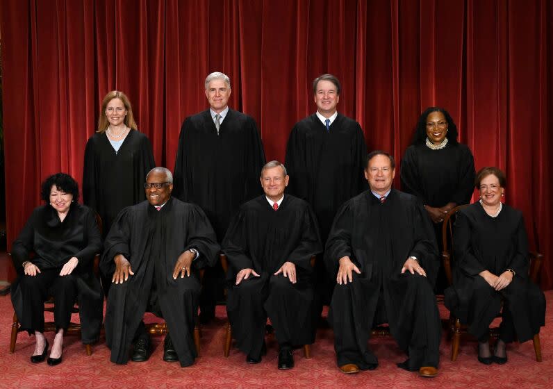 Justices of the US Supreme Court pose for their official photo at the Supreme Court in Washington, DC on October 7, 2022. - (Seated from left) Associate Justice Sonia Sotomayor, Associate Justice Clarence Thomas, Chief Justice John Roberts, Associate Justice Samuel Alito and Associate Justice Elena Kagan, (Standing behind from left) Associate Justice Amy Coney Barrett, Associate Justice Neil Gorsuch, Associate Justice Brett Kavanaugh and Associate Justice Ketanji Brown Jackson. (Photo by OLIVIER DOULIERY / AFP) (Photo by OLIVIER DOULIERY/AFP via Getty Images)