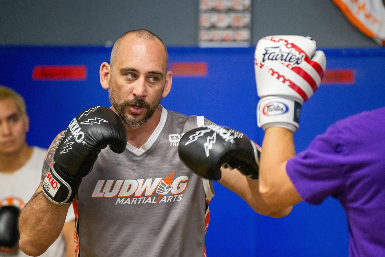 Sky Rudloe, owner of Train. Fight. Win., demonstrates a skills for students to practice during a class on Tuesday, April 30, 2024.