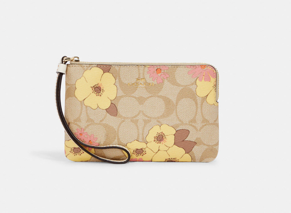 Corner Zip Wristlet In Signature Canvas With Floral Cluster Print. Image via Coach Outlet.