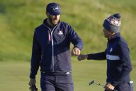 Team USA's Dustin Johnson and Team USA's Collin Morikawa react on the second hole during a foursomes match the Ryder Cup at the Whistling Straits Golf Course Saturday, Sept. 25, 2021, in Sheboygan, Wis. (AP Photo/Jeff Roberson)