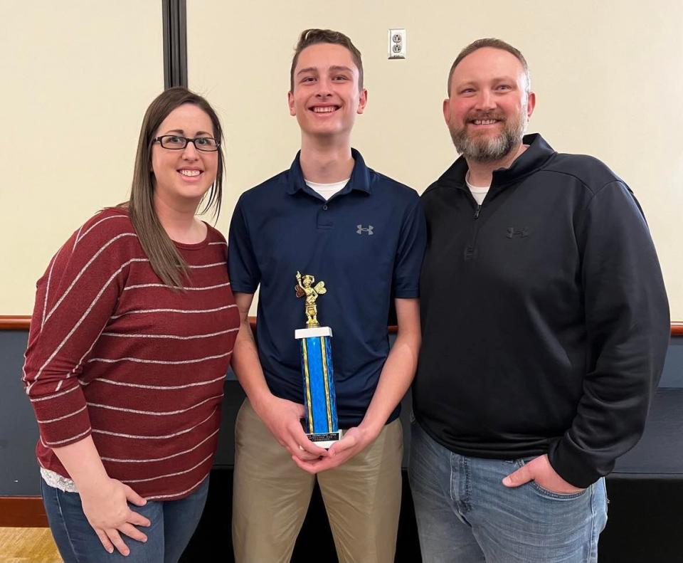 Bryce Beckley, 14, of Dover Middle School, is shown with his parents, Lyndy and Alan Beckley, after winning The Canton Repository's 77th Regional Final Spelling Bee on March 4 at Kent State University at Stark's Conference Center.
