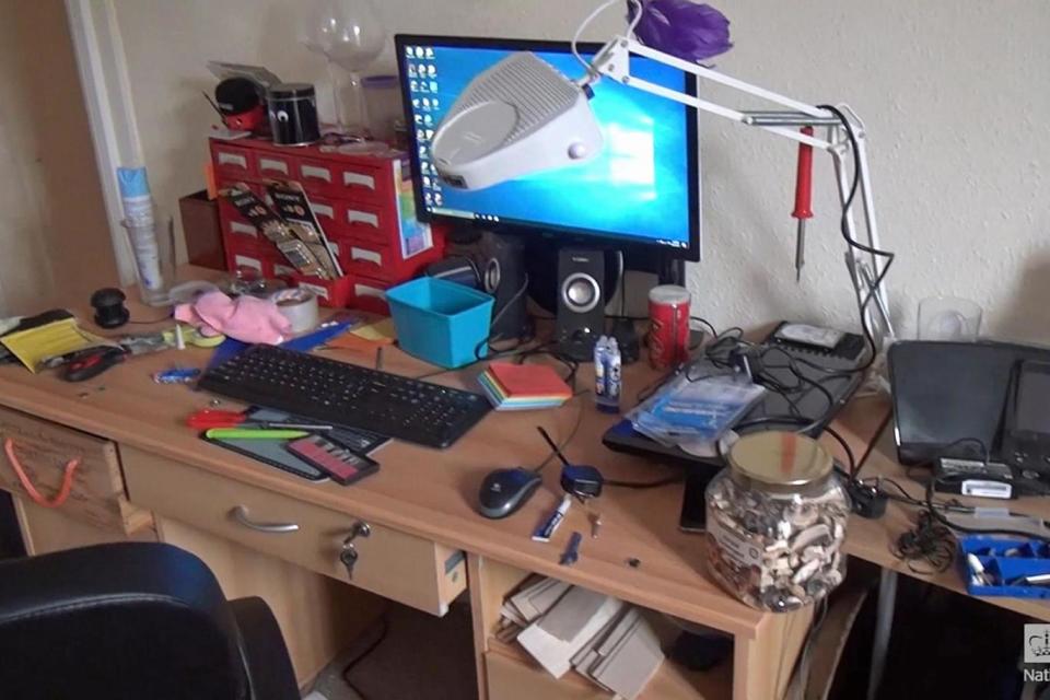 Photo of Matthew Falder's flat showing his desk and computer (PA)