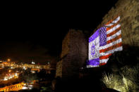 An Israeli national flag and an American one are projected on a part of the walls surrounding Jerusalem's Old City December 6, 2017. REUTERS/Ronen Zvulun