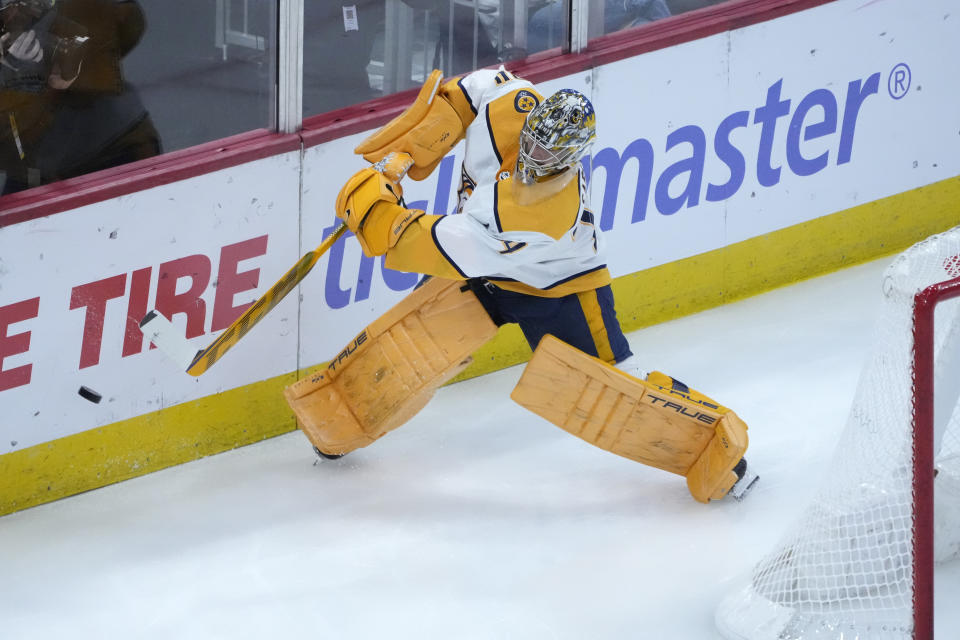 Nashville Predators goaltender Juuse Saros clears the puck from behind the net during the first period of an NHL hockey game against the Chicago Blackhawks, Saturday, March 4, 2023, in Chicago. (AP Photo/Charles Rex Arbogast)