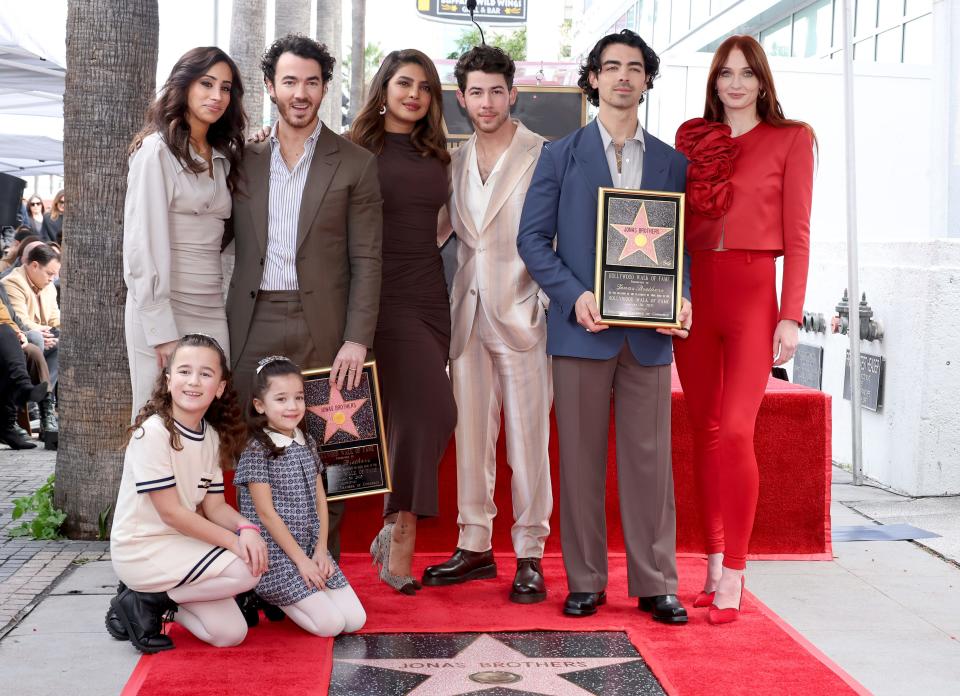 Danielle Jonas, Kevin Jonas, Priyanka Chopra, Nick Jonas, Joe Jonas, Sophie Turner, and (front) Alena Rose Jonas and Valentina Angelina Jonas attend The Hollywood Walk of Fame star ceremony honoring The Jonas Brothers in Hollywood, California.