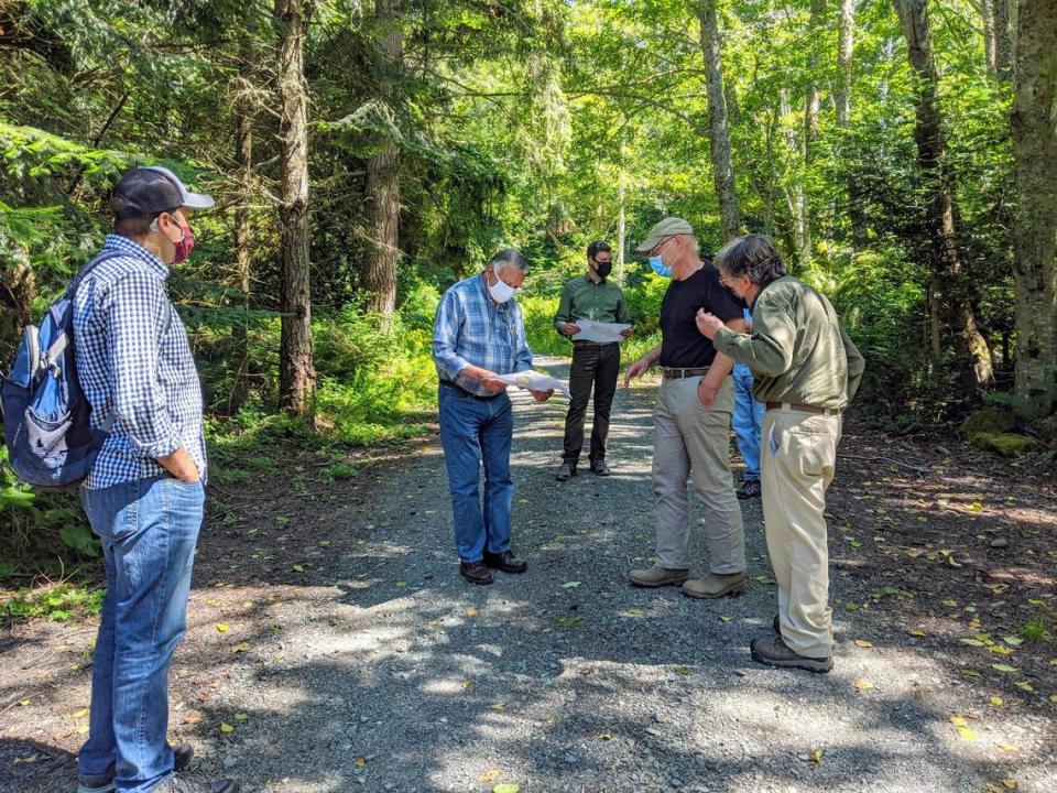 Whatcom County Executive Satpal Sidhu stands with Deputy Executive Tyler Schroeder and Rand Jack, a board member of the Whatcom Land Trust, and others, during a summer 2020 visit to Governors Point.
