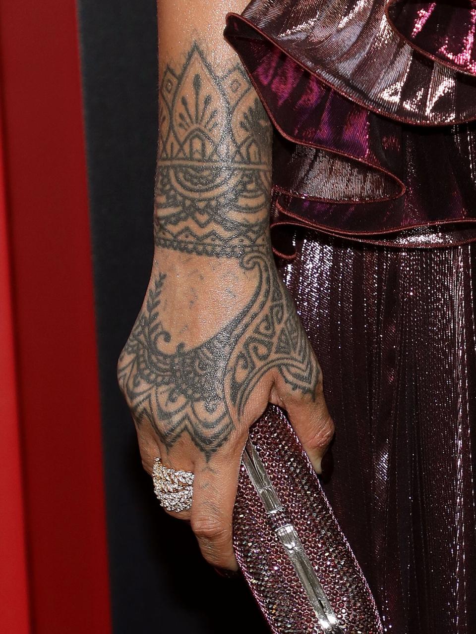 Rihanna, clutch and tattoo detail, attends the world premiere of "Ocean's 8" at Alice Tully Hall at Lincoln Center on June 5, 2018 in New York City