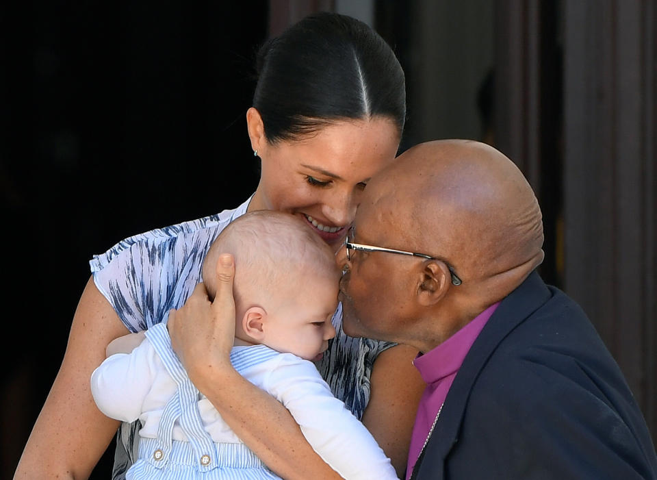 Archie receives a kiss from Archbishop Desmond Tutu. Photo: REUTERS/Toby Melville/Pool