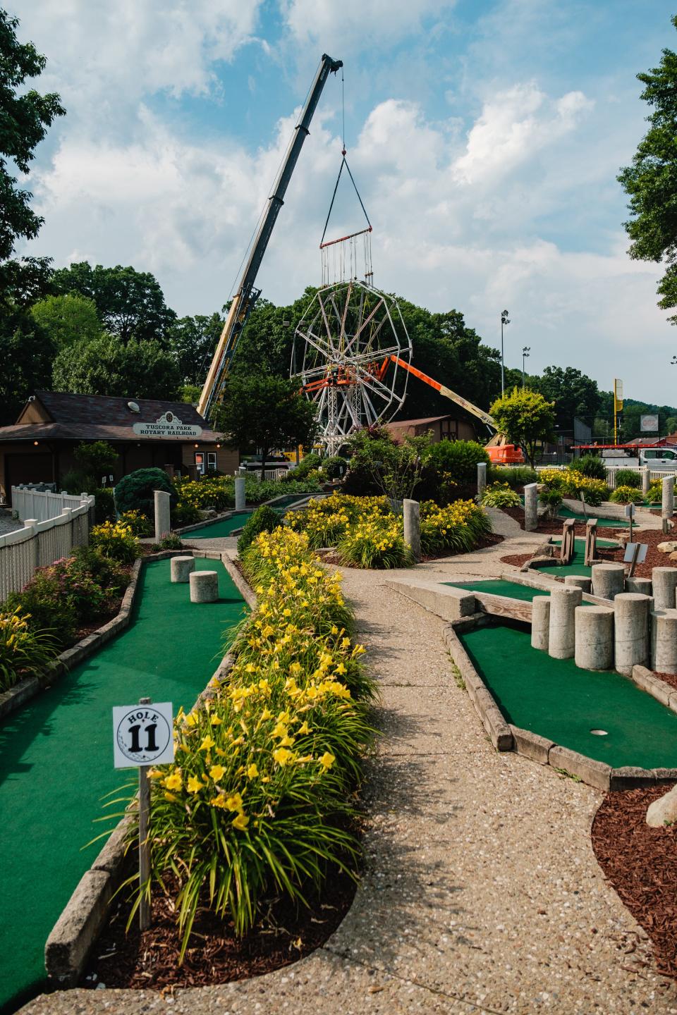 Work is performed on the Tuscora Park Ferris wheel June 17, in New Philadelphia.