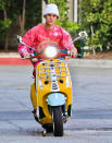 <p>Justin Bieber enjoys a ride around Beverly Hills on his yellow scooter on Monday.</p>